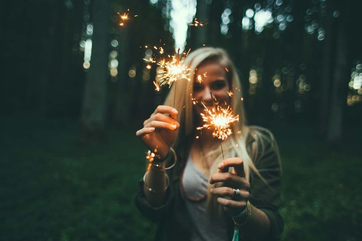 image of girl holding sparkles